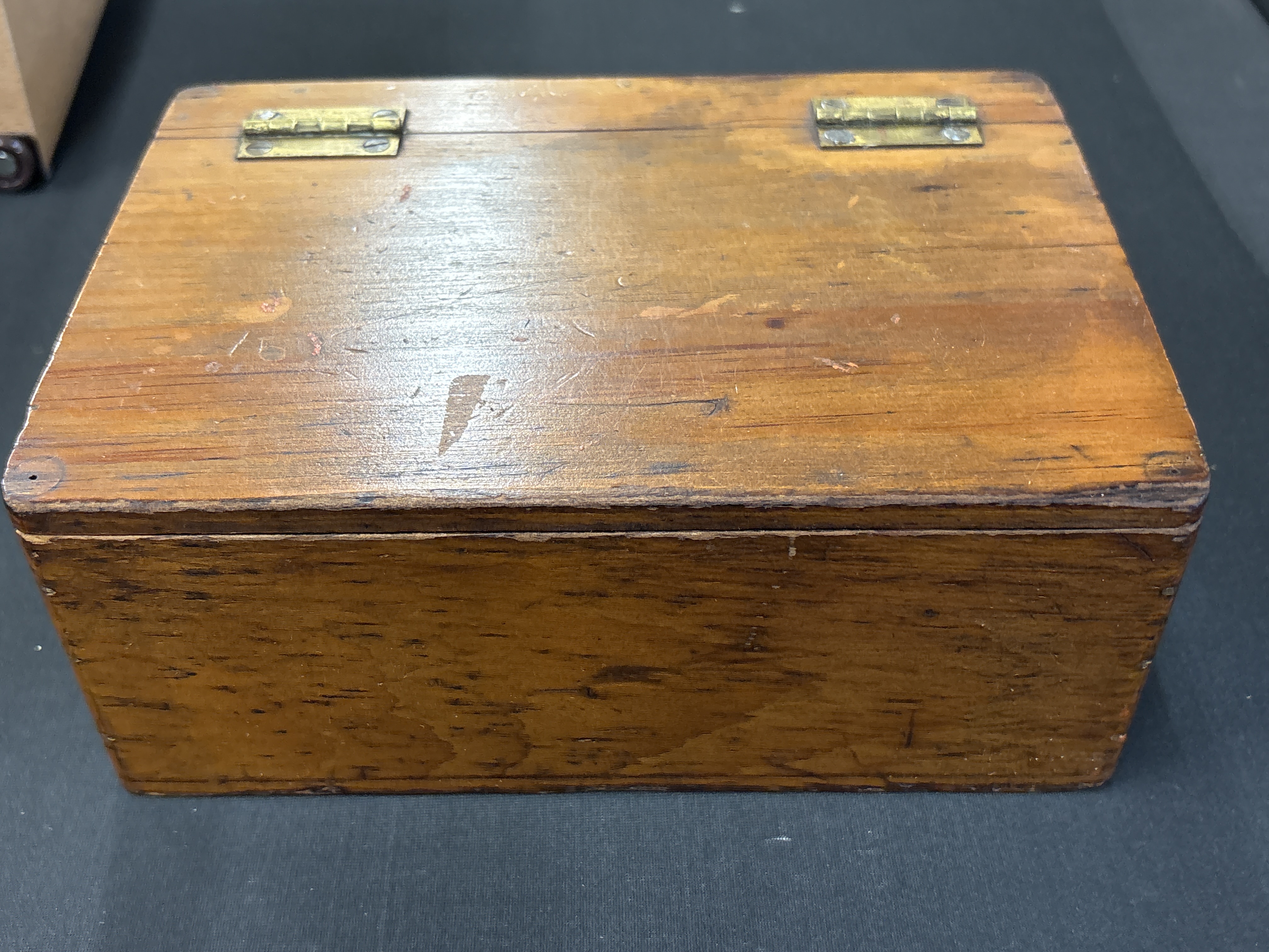 A Small Stained Oak Utilitarian Storage Box with Brass Hinges