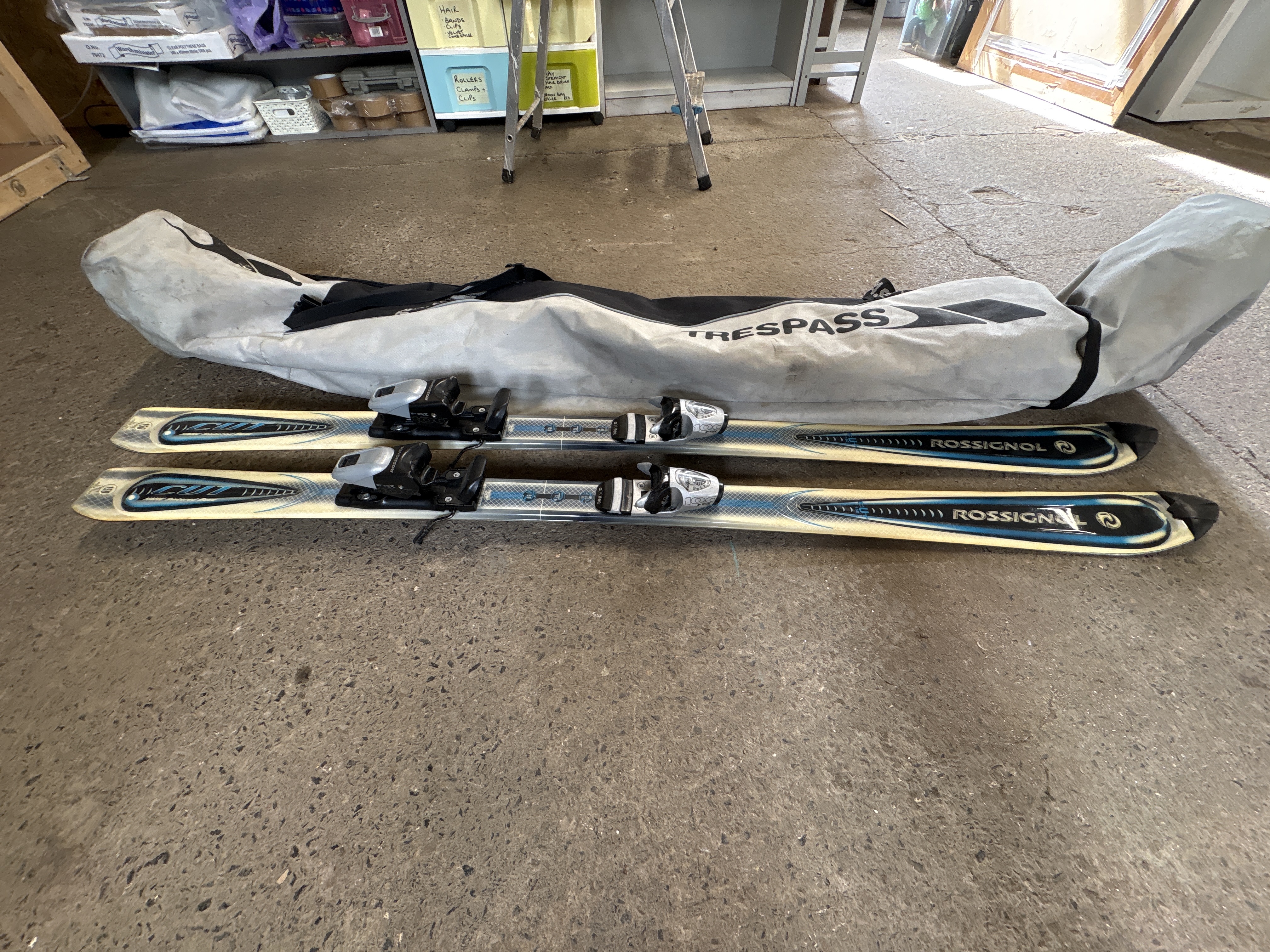 A Pair of Rossignol Cut Alpine Skis with Bindings and a Trespass Carry Bag