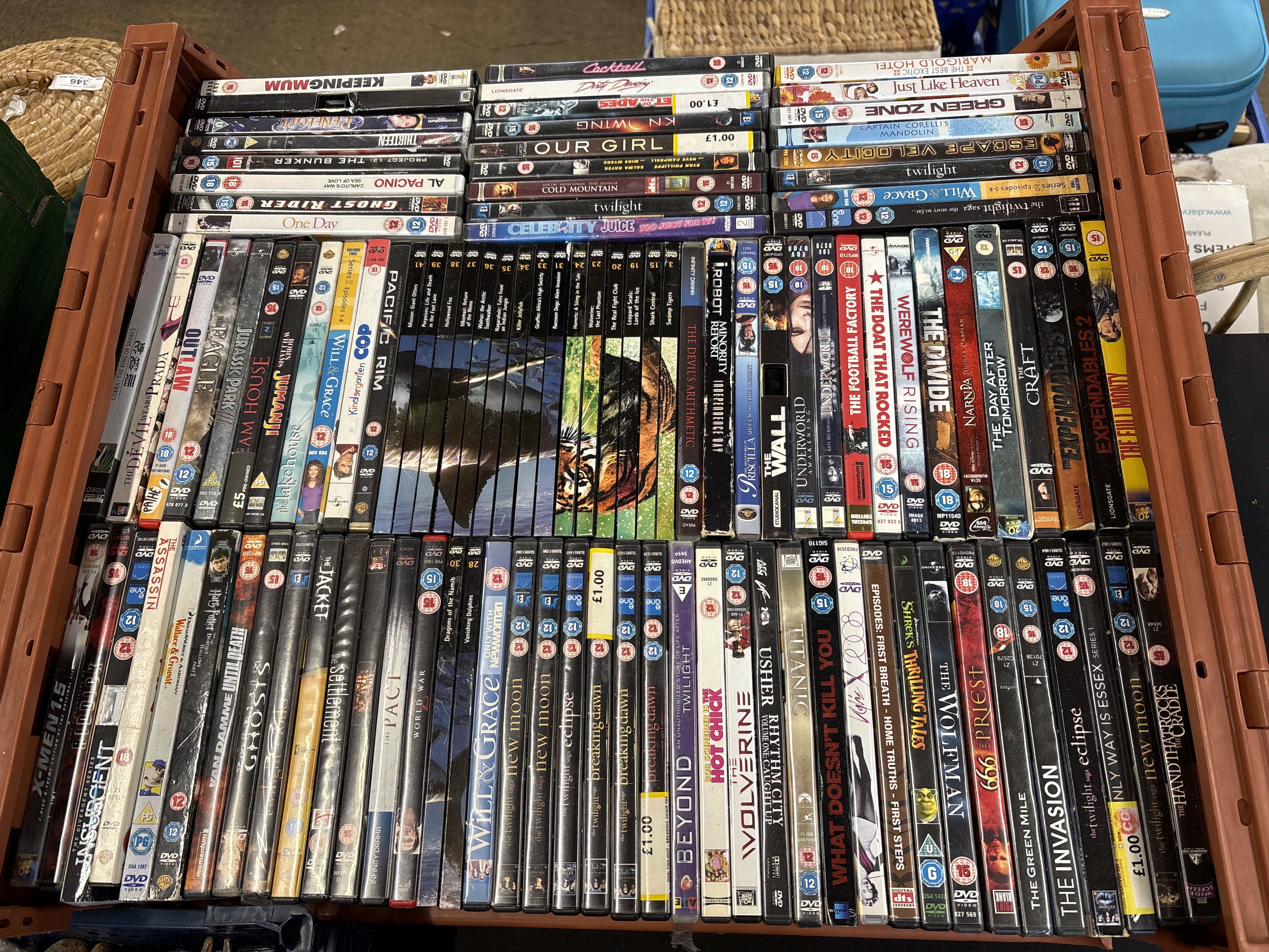 A Large Collection of Assorted DVDs in an Orange Plastic Crate