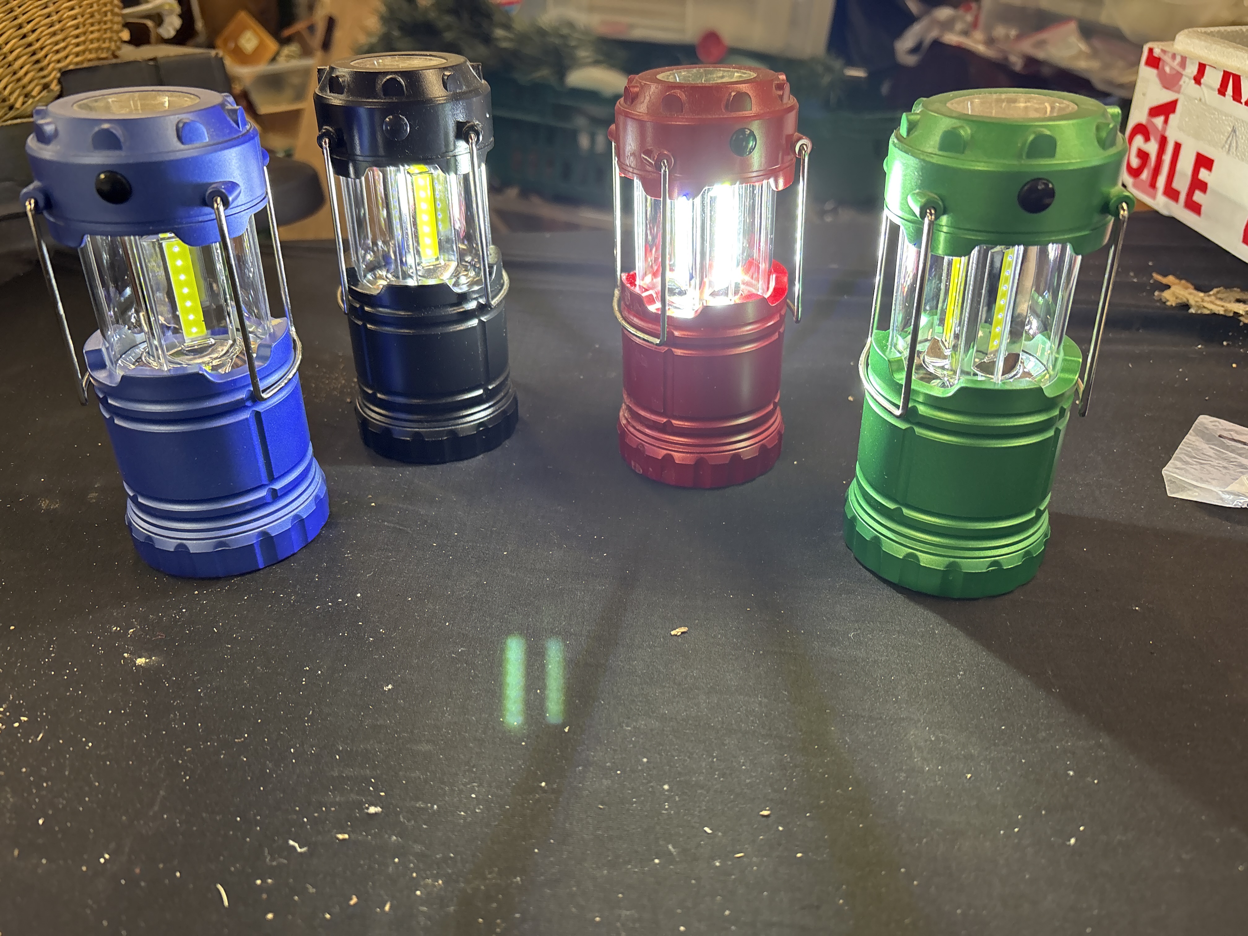 A Set of Four Collapsible COB LED Camping Lanterns in Assorted Colours