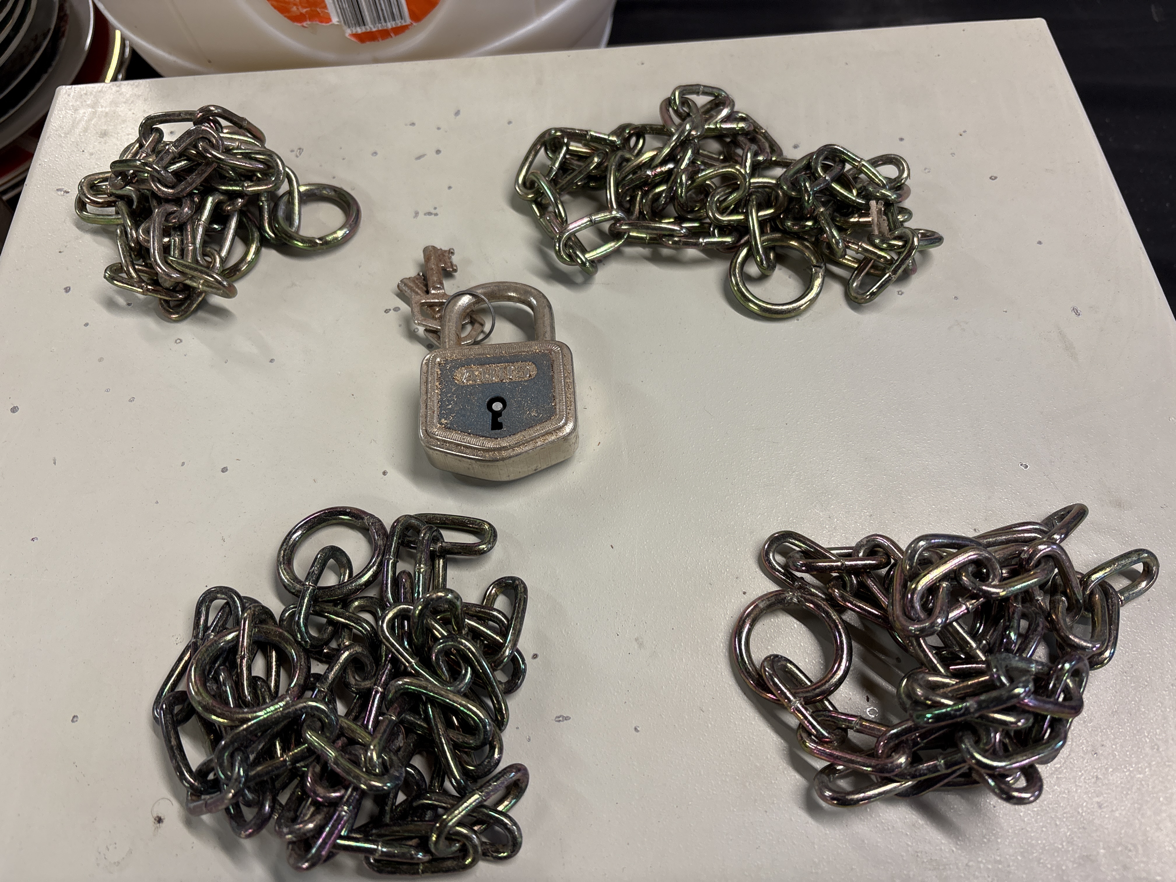 An Assortment of Industrial Security Chains and an ABUS 85/50 Padlock with Keys