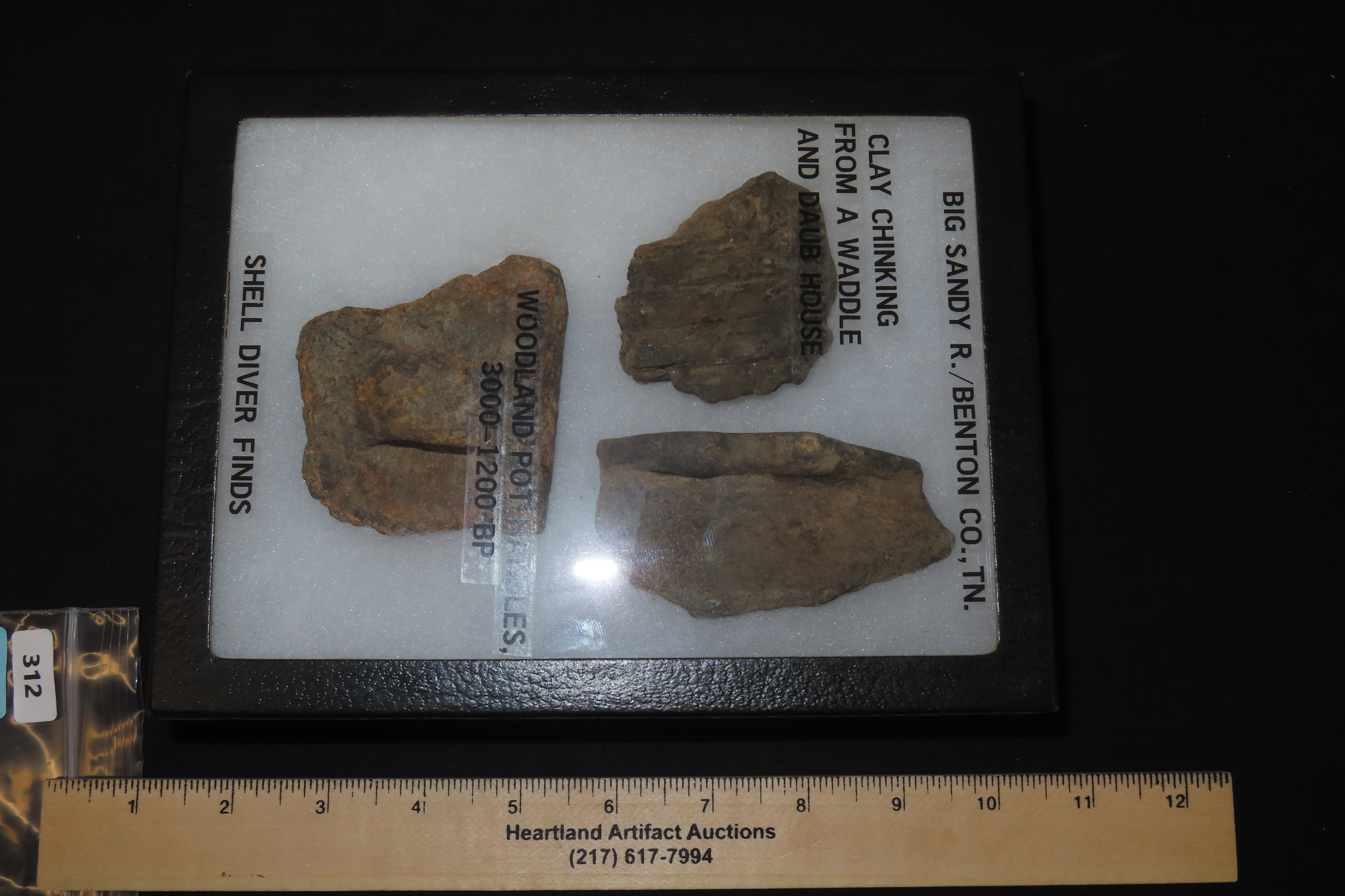 8" x 7" Riker Frame Containing House Floor Artifacts and Woodland Pottery Handles, Big Sandy River, Benton Co., Tennessee, Shell Diver Finds