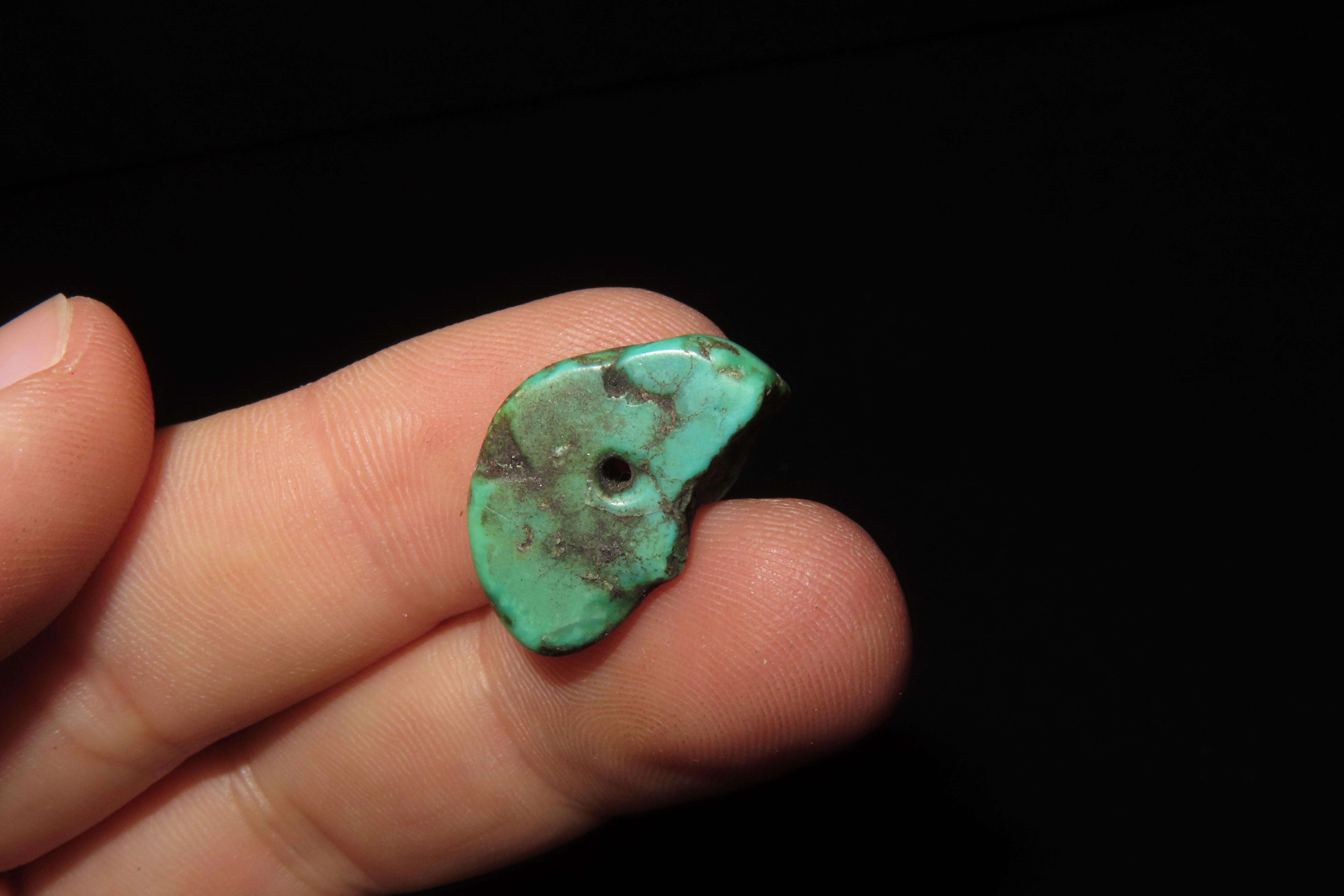 Colorful Mimbres / Hohokam Turquoise Pendant found in Arizona. Nicely shaped and polished example, drilled for suspension.