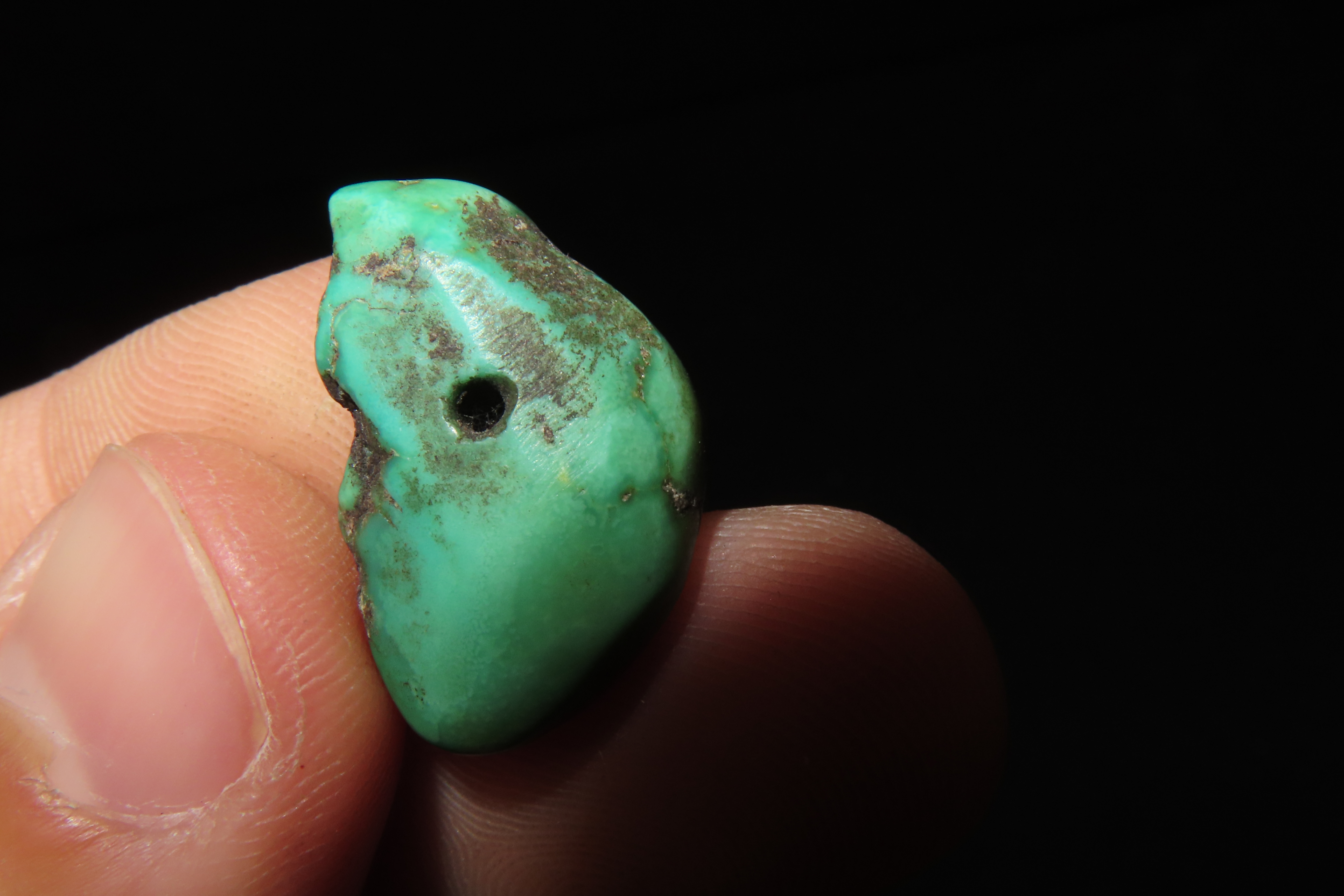 Colorful Mimbres / Hohokam Turquoise Pendant found in Arizona. Nicely shaped and polished example, drilled for suspension.