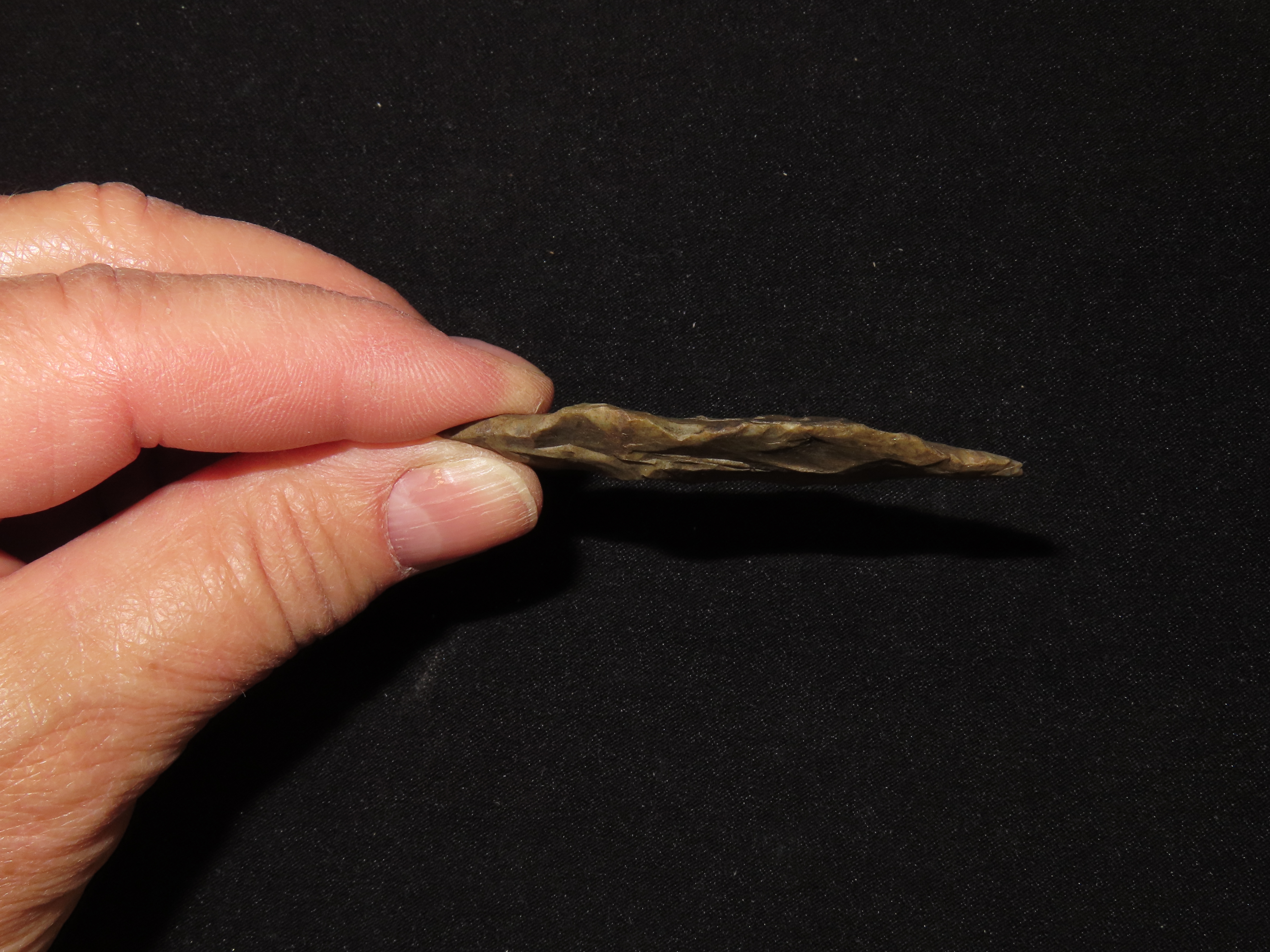 2 5/8" Paleo Suwanee found in Soutehrn Georgia. Heavily patinated old Indian Arrowhead.