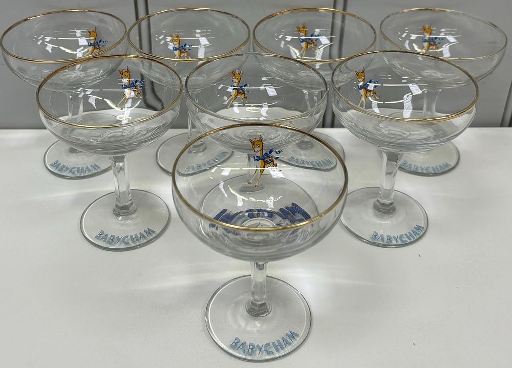 Set of eight vintage Babycham Glasses. Light blue lettering &amp; gold-coloured rims. 11cm tall.