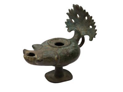 A ROMAN BRONZE LAMP WITH GRAPE-LEAF HANDLE, CA. 1ST-2ND CENTURY AD. A bronze oil lamp from the