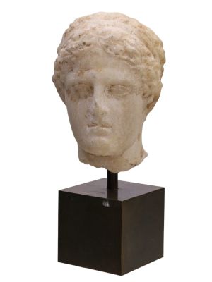A ROMAN MARBLE HEAD WITH AN ATHLETE'S DIADEM, CA. 1ST CENTURY AD. This marble head of possible