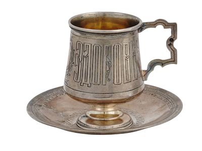 A RUSSIAN SILVER CUP AND SAUCER BY MILYUKOV, 1896. The cup is engraved with a Russian saying: