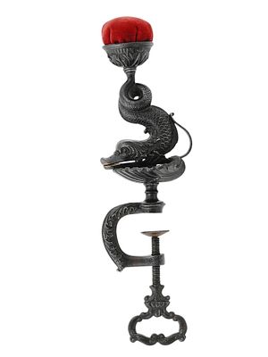A EUROPEAN CHASED IRON SEA SERPENT PINCUSHION WITH TABLE MOUNT, 19 C. An ornate, chased iron