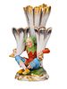 A SEATED HARLEQUIN WITH THREE CORNUCOPIA VASES, AICH PORCELAIN MANUFACTORY, BOHEMIA, CIRCA 1850. Image - 1