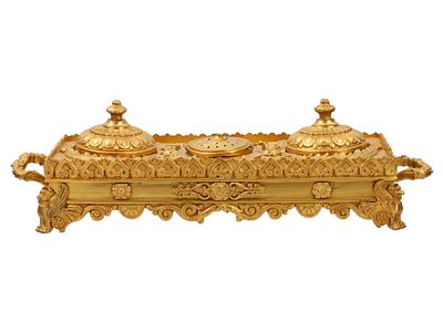 A GILT-BRONZE INKWELL SET, 19TH CENTURY. Of rectangular form, richly cast and chased in high 