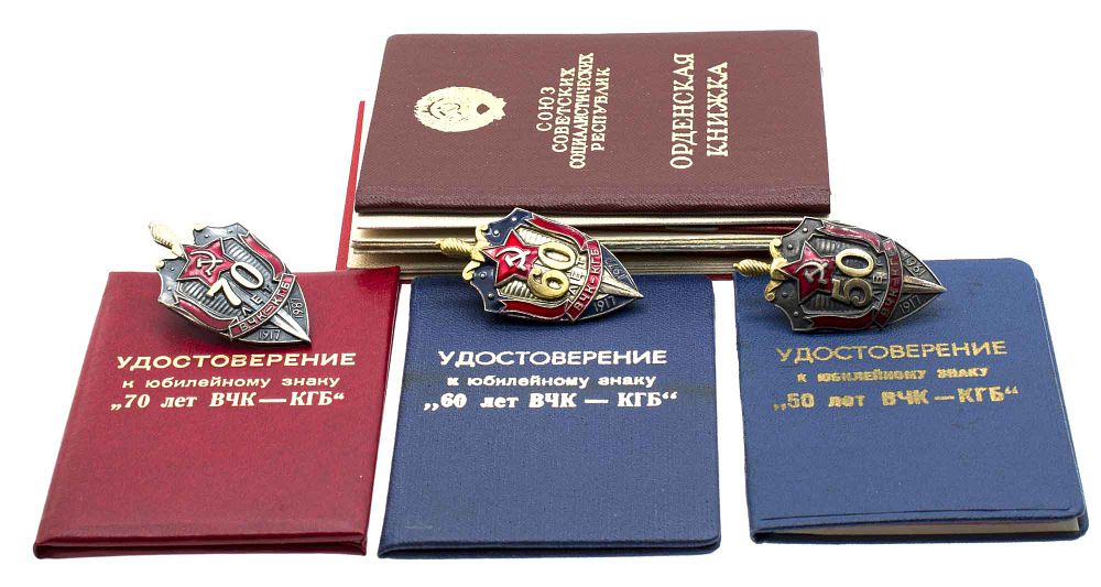 A COMPLETE SET OF THREE SOVIET ANNIVERSARY KGB BADGES WITH DOCUMENTS. A complete set of three 