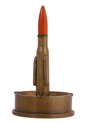 A TRENCH-ART SHELL CASE ASHTRAY WITH PAINTED BULLET. Trench-art novelty formed from a large 