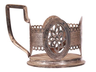 A RUSSIAN ENGRAVED SILVER TEA GLASS HOLDER. Of circular form with a raised base and a shaped 