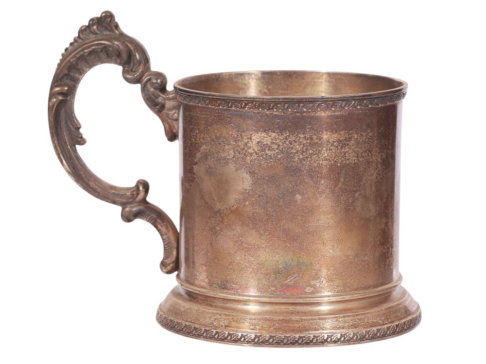 A RUSSIAN PARCEL-GILT SILVER TEA GLASS HOLDER. Of cylindrical form with a flaring circular base 