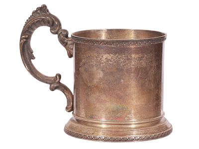 A RUSSIAN PARCEL-GILT SILVER TEA GLASS HOLDER. Of cylindrical form with a flaring circular base 