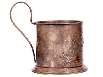 A SOVIET SILVER-ALLOY TEA GLASS HOLDER WITH TROIKA. Of cylindrical form on a spreading circular 