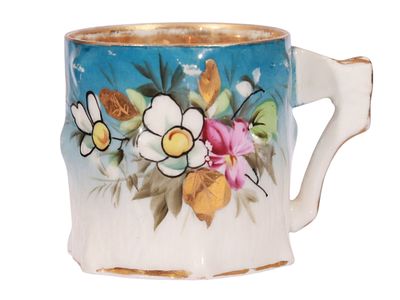 A KUZNETSOV GILT AND PAINTED PORCELAIN COFFEE CUP. A finely modeled porcelain coffee cup by the 