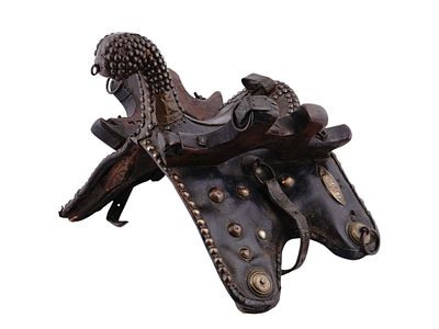 AN OTTOMAN OR BERBER NOBLEMAN'S SADDLE WITH BRASS STUDS, 19TH CENTURY. This is a North African 