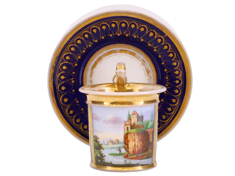 A FRENCH PORCELAIN CUP AND SAUCER WITH COBALT-BLUE GROUND AND LANDSCAPE PANEL, EARLY 19TH CENTURY. 