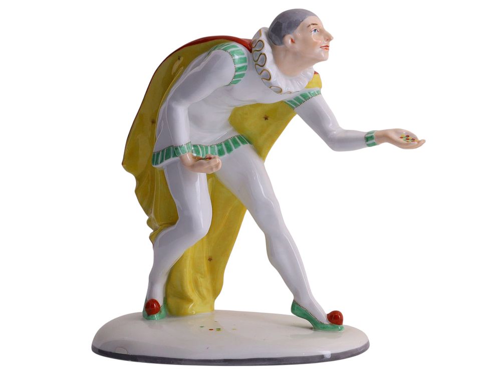A PORCELAIN FIGURE OF A JESTER WITH CONFETTI, PIRKEN HAMMER, CZECHOSLOVAKIA, CIRCA 1930. Porcelai 