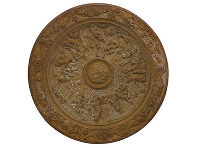 A CAST-BRONZE REPOUSS&Eacute; TRAY WITH NEOCLASSICAL MOTIFS, 19TH CEN. A large circular bronze tray 