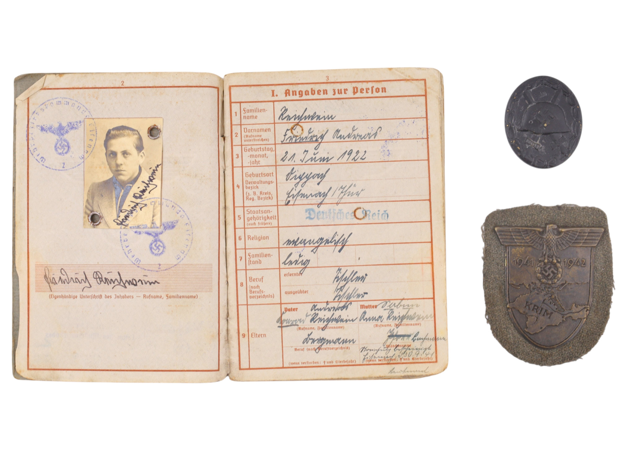 A GERMAN WEHRPASS GROUPING WITH WOUND BADGE AND CRIMEA CAMPAIGN SHIELD
