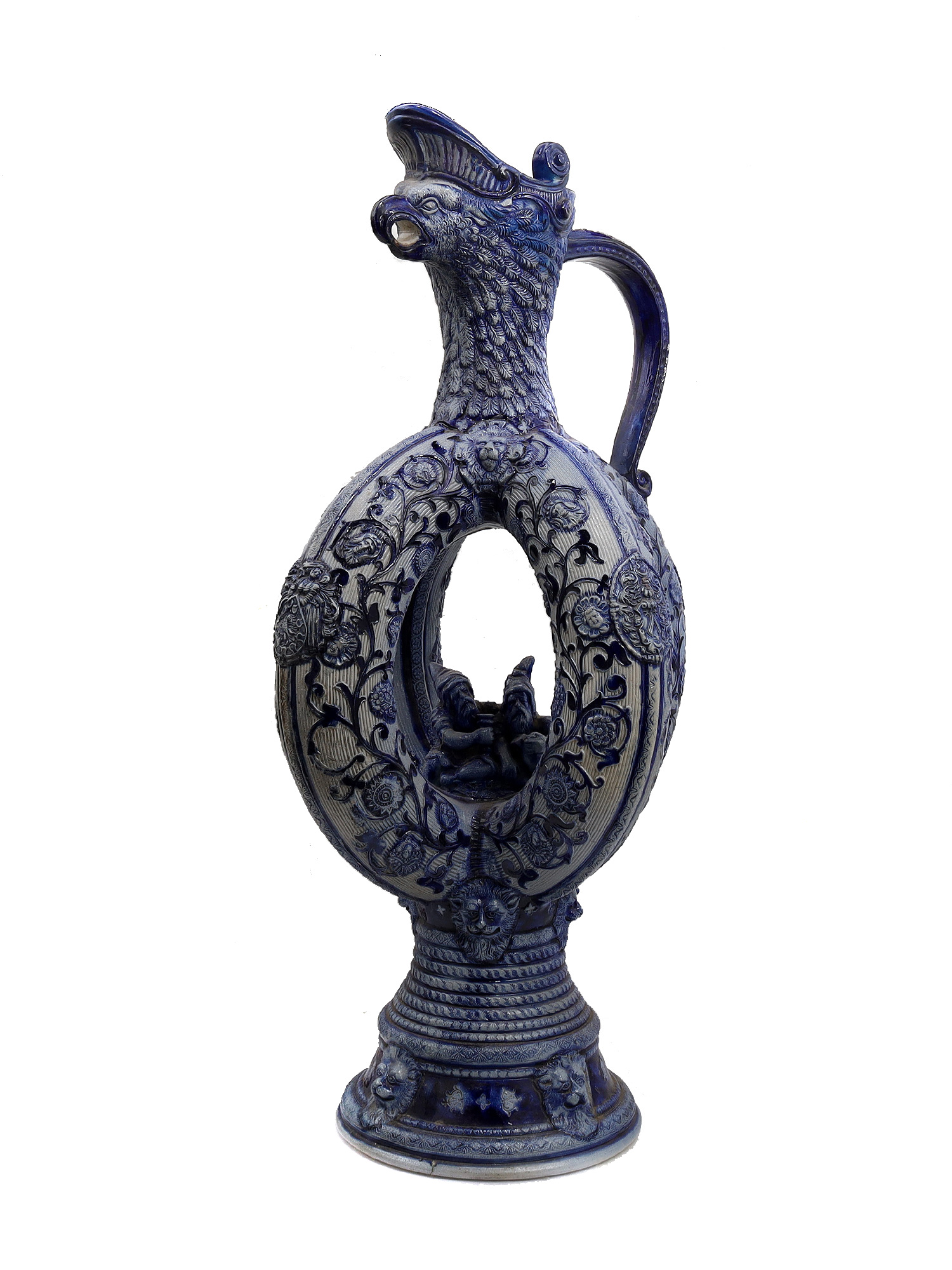 A GERMAN GLAZED CERAMIC PRETZEL EWER WITH DWARFS