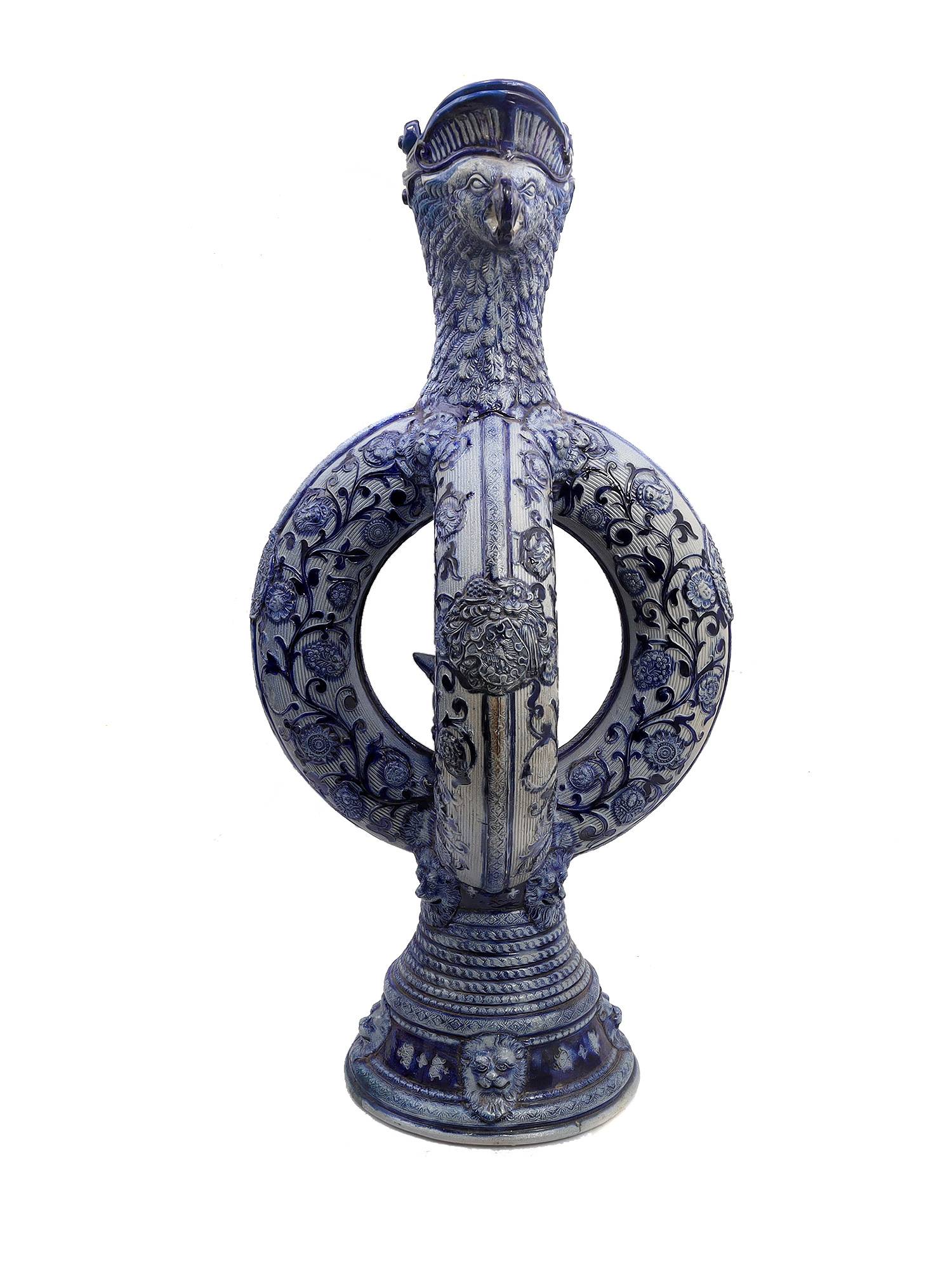 A GERMAN GLAZED CERAMIC PRETZEL EWER WITH DWARFS