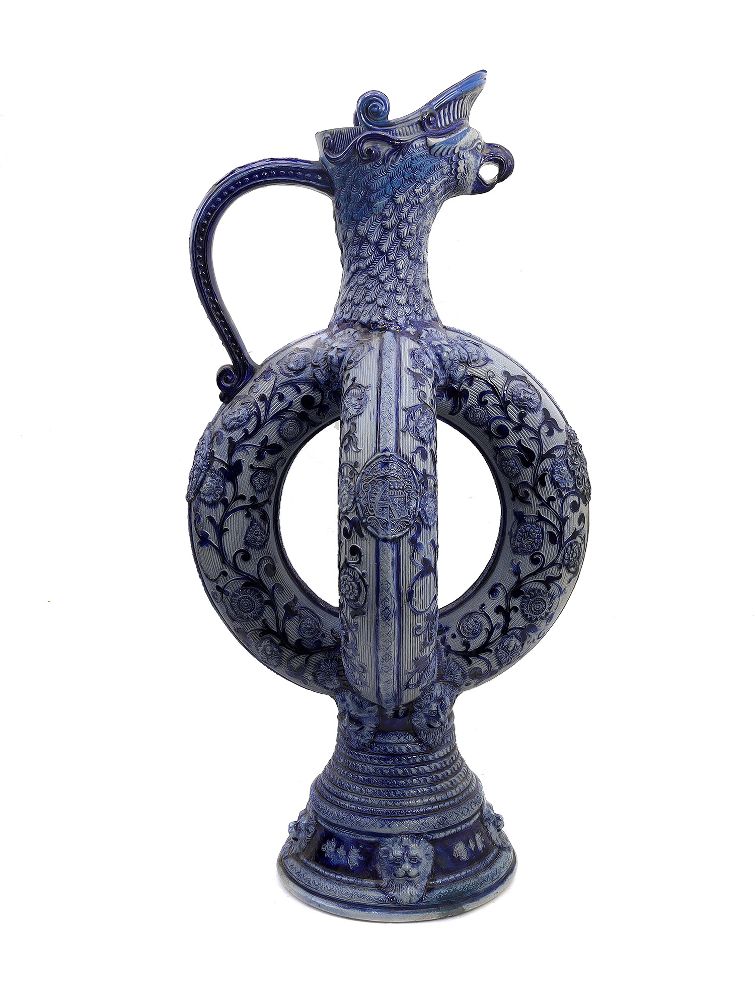 A GERMAN GLAZED CERAMIC PRETZEL EWER WITH DWARFS