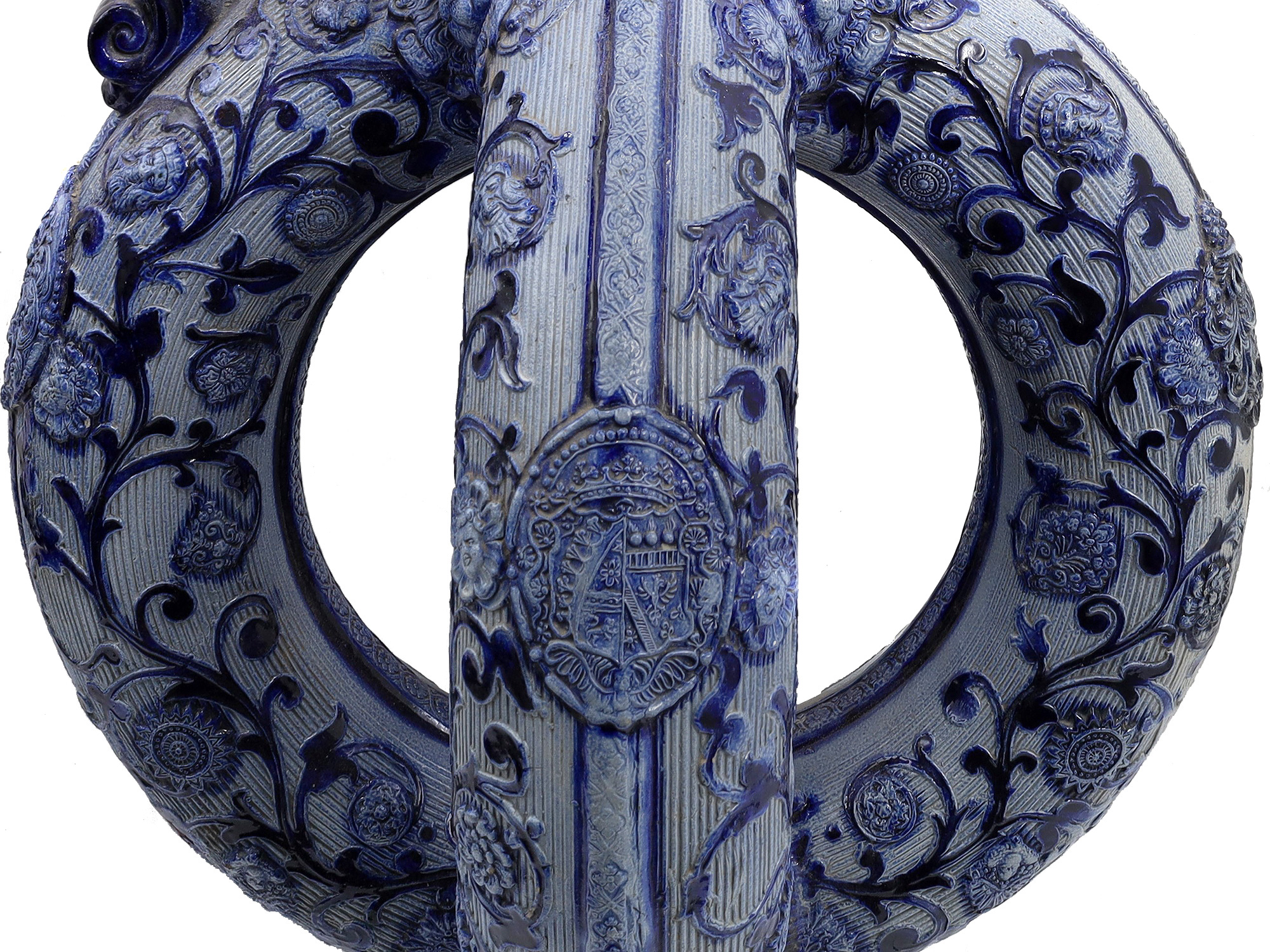 A GERMAN GLAZED CERAMIC PRETZEL EWER WITH DWARFS