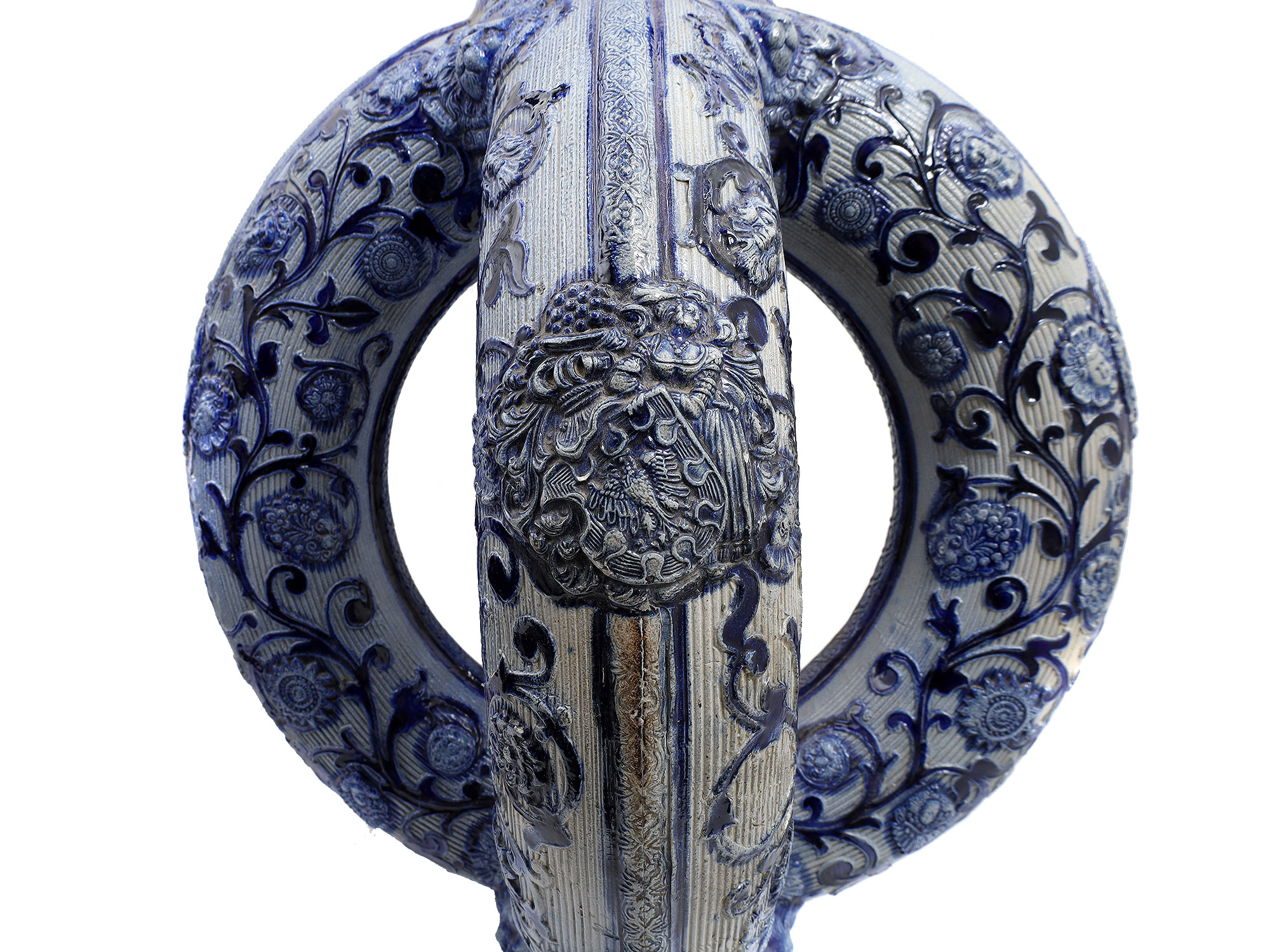 A GERMAN GLAZED CERAMIC PRETZEL EWER WITH DWARFS