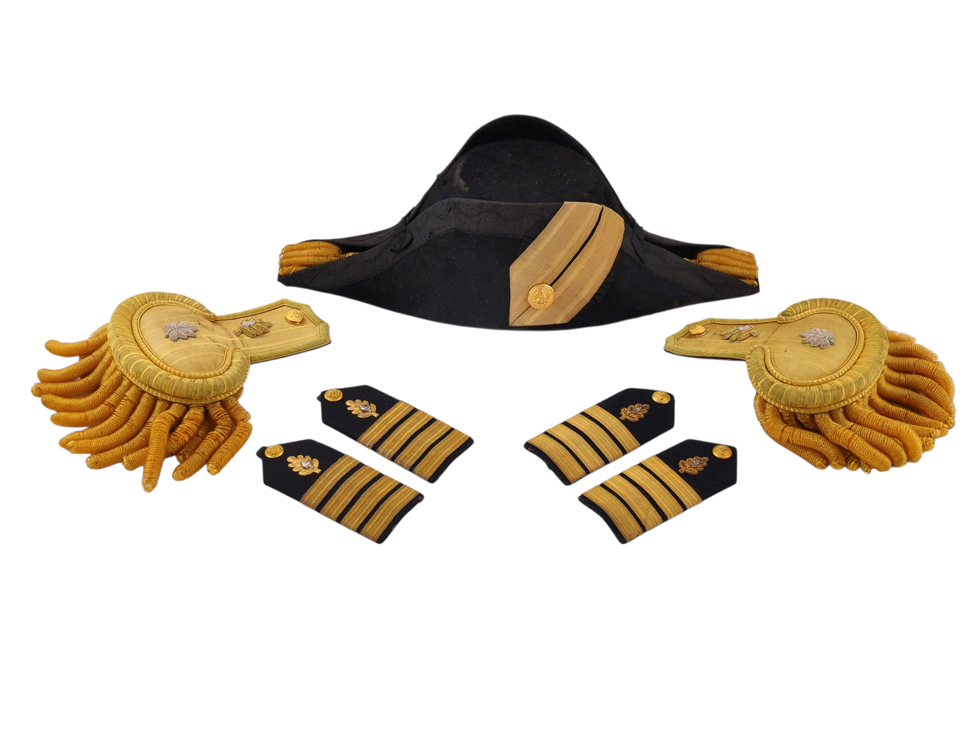 A BRITISH ROYAL NAVY CAPTAIN'S FULL DRESS BICORNE HAT AND EPAULETTES IN A TOLE CASE