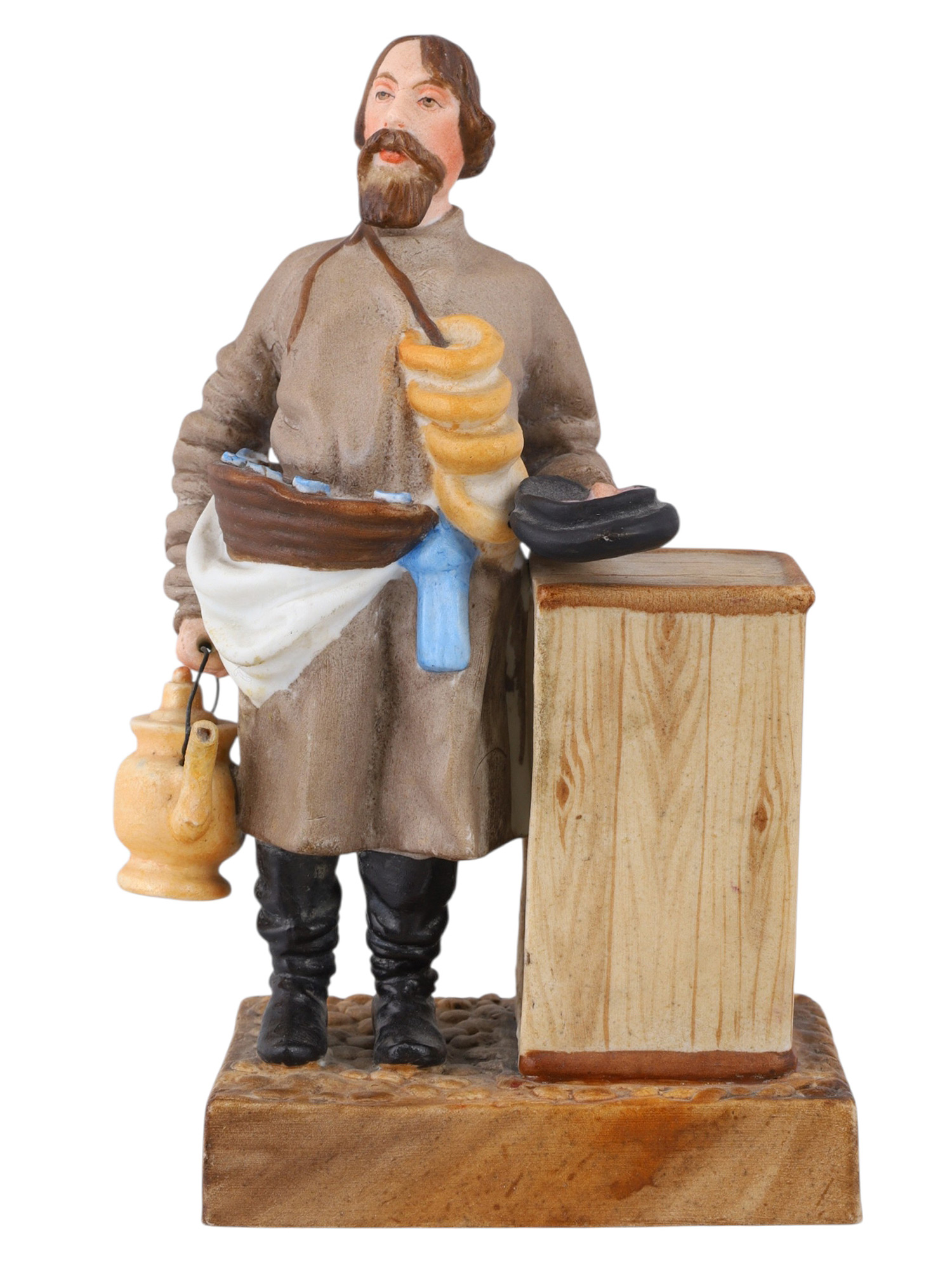 A RUSSIAN KUZNETSOV/GARDNER PORCELAIN FIGURE OF A SBITEN VENDOR, 19TH CENTURY