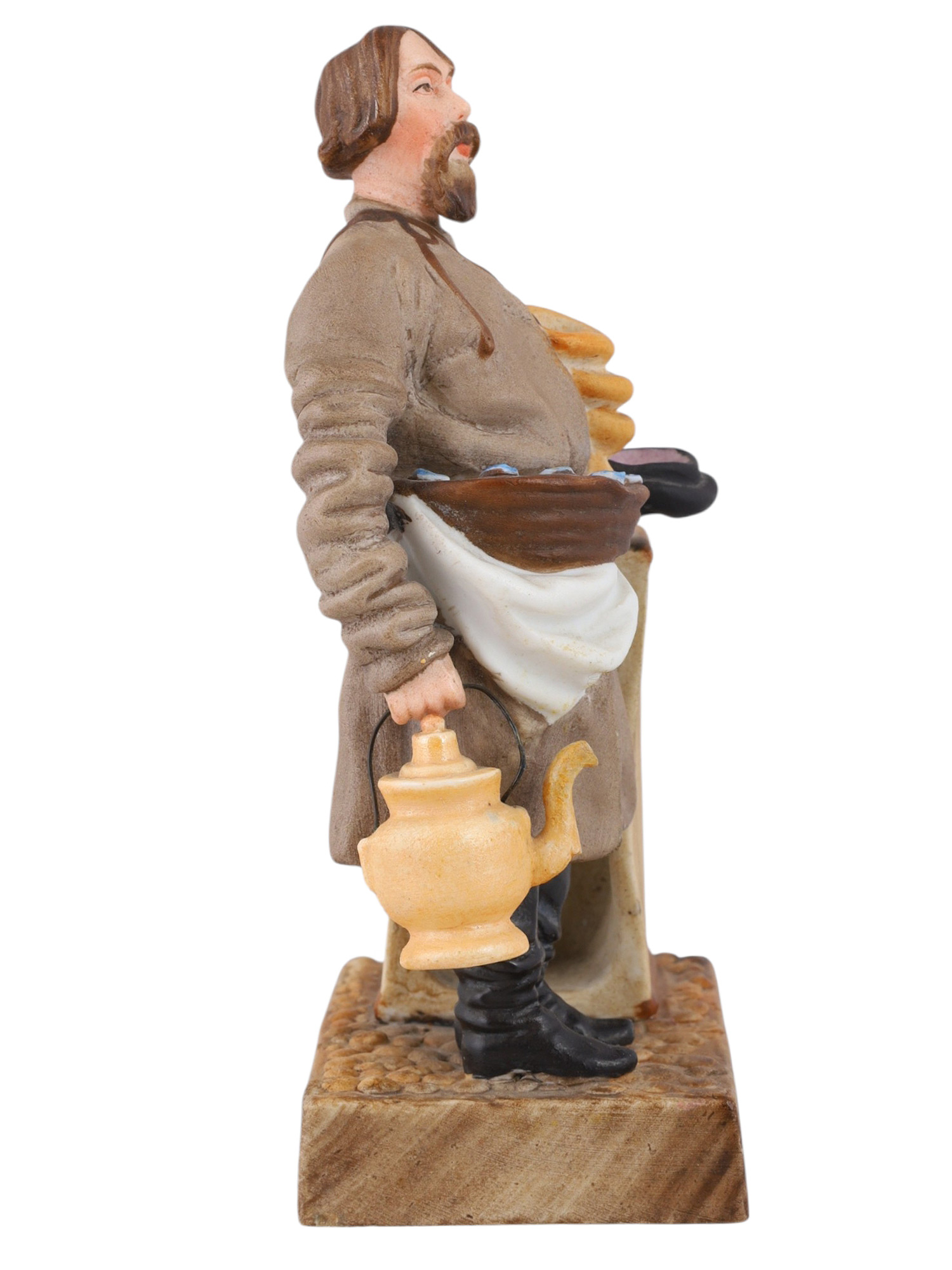 A RUSSIAN KUZNETSOV/GARDNER PORCELAIN FIGURE OF A SBITEN VENDOR, 19TH CENTURY