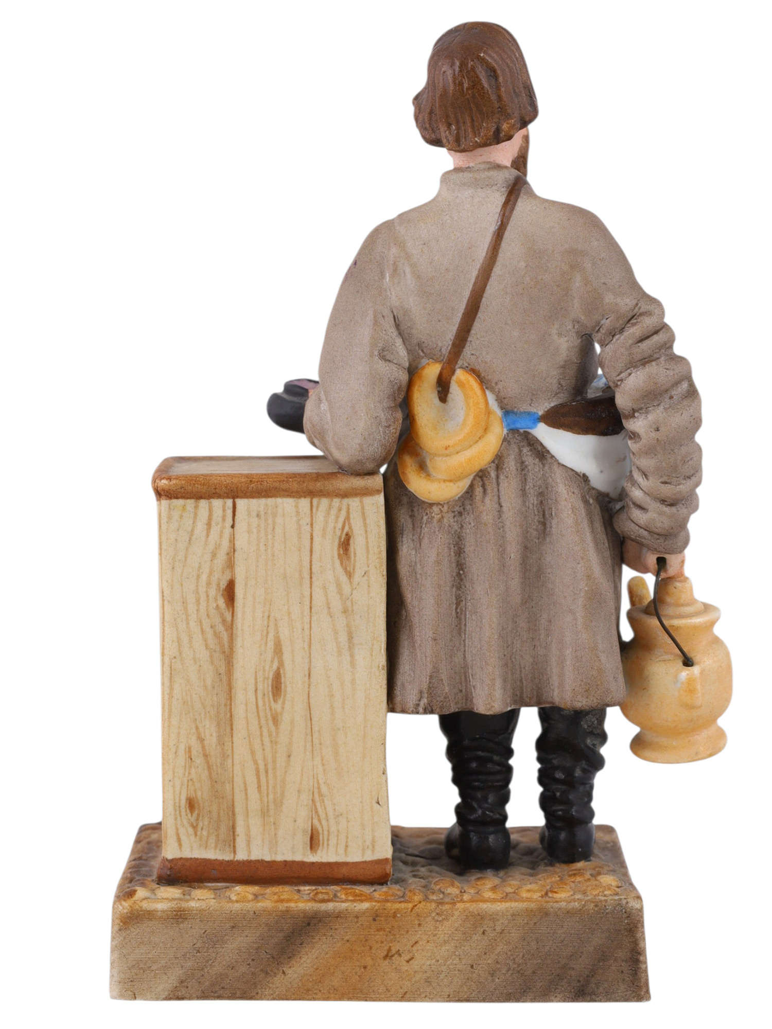 A RUSSIAN KUZNETSOV/GARDNER PORCELAIN FIGURE OF A SBITEN VENDOR, 19TH CENTURY