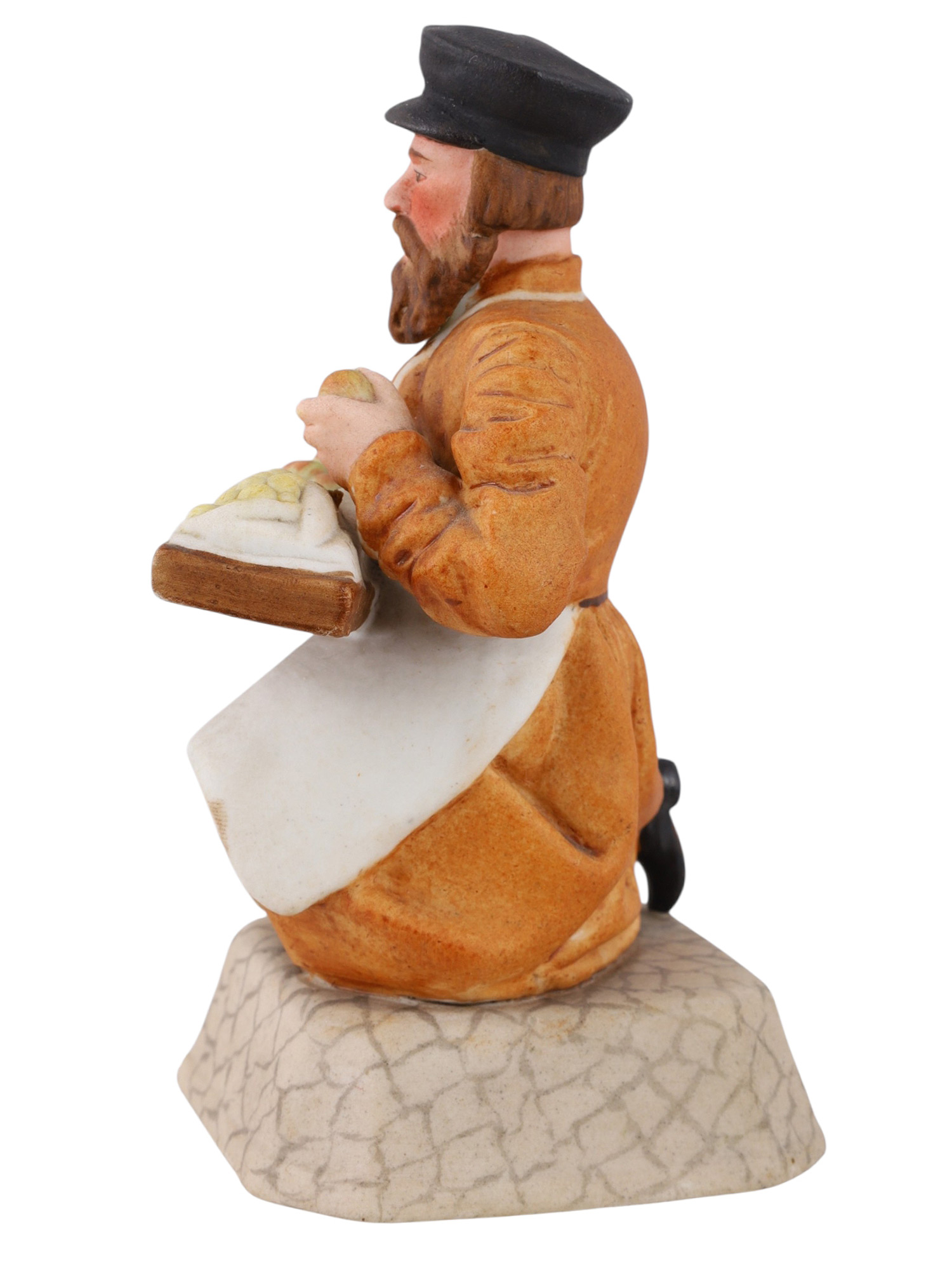 A RUSSIAN PORCELAIN FIGURE OF A FOOD VENDOR BY THE GARDNER PORCELAIN FACTORY, VERBILKI, LATE 19TH CENTURY