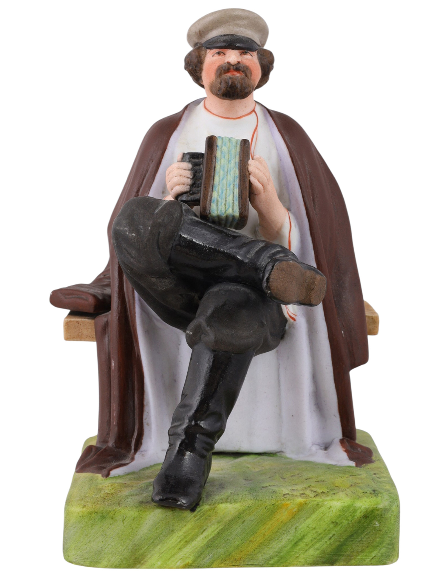 A RUSSIAN GARDNER PORCELAIN FIGURE OF AN ACCORDION PLAYER