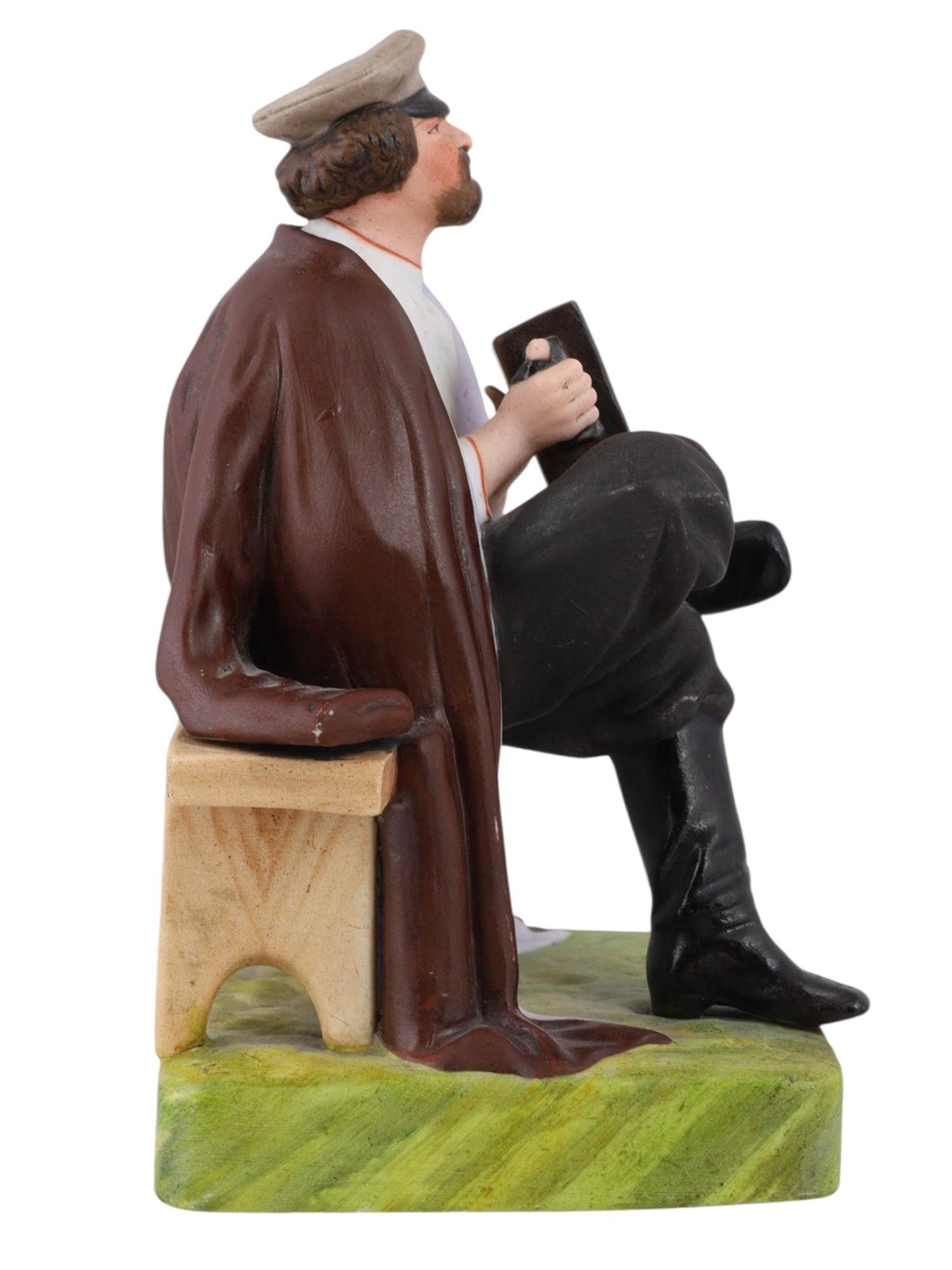 A RUSSIAN GARDNER PORCELAIN FIGURE OF AN ACCORDION PLAYER