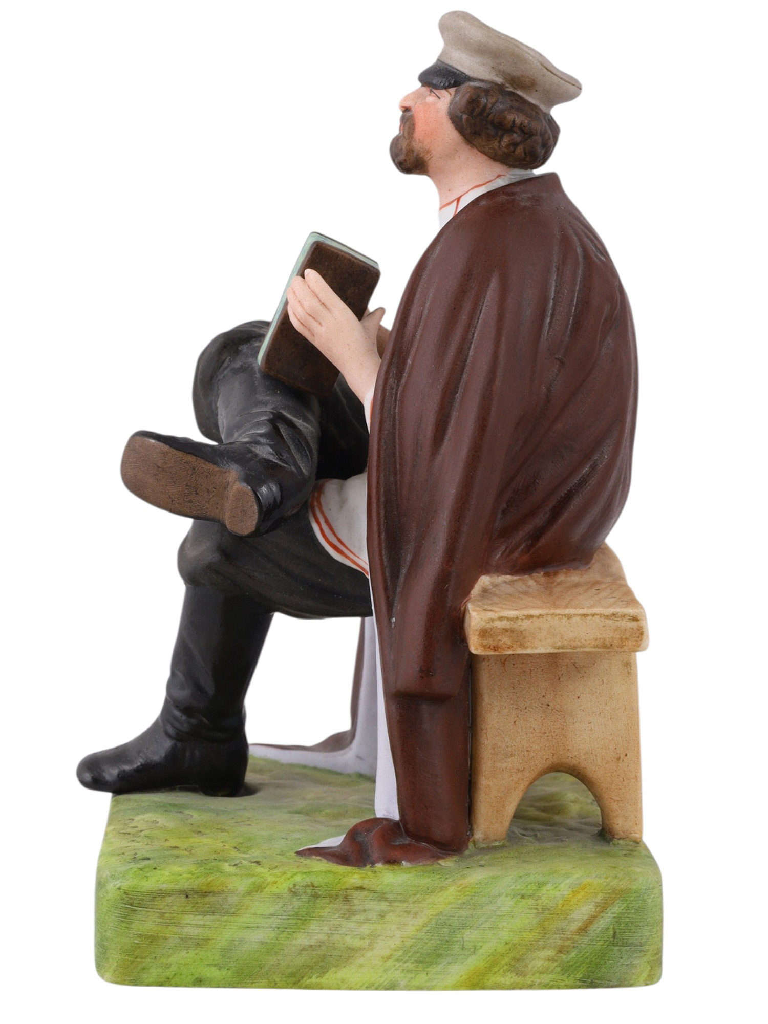 A RUSSIAN GARDNER PORCELAIN FIGURE OF AN ACCORDION PLAYER