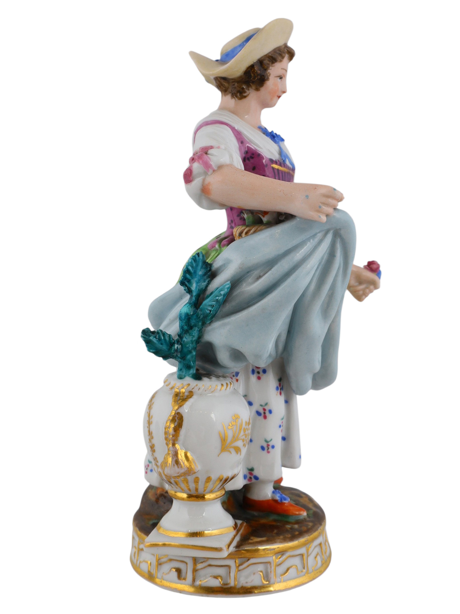 A RUSSIAN POPOV PORCELAIN FIGURE OF A WOMAN WITH FLOWERS