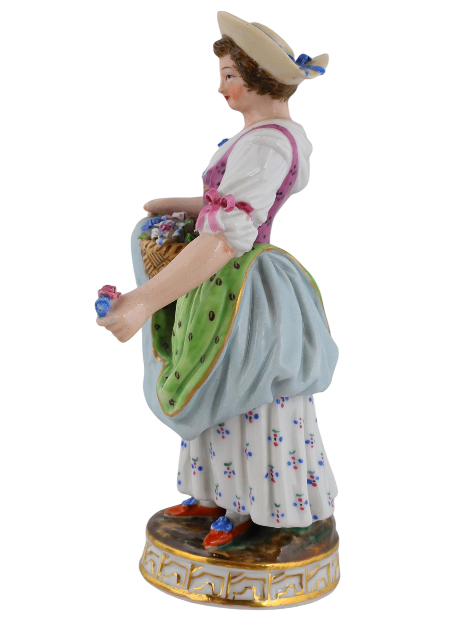 A RUSSIAN POPOV PORCELAIN FIGURE OF A WOMAN WITH FLOWERS