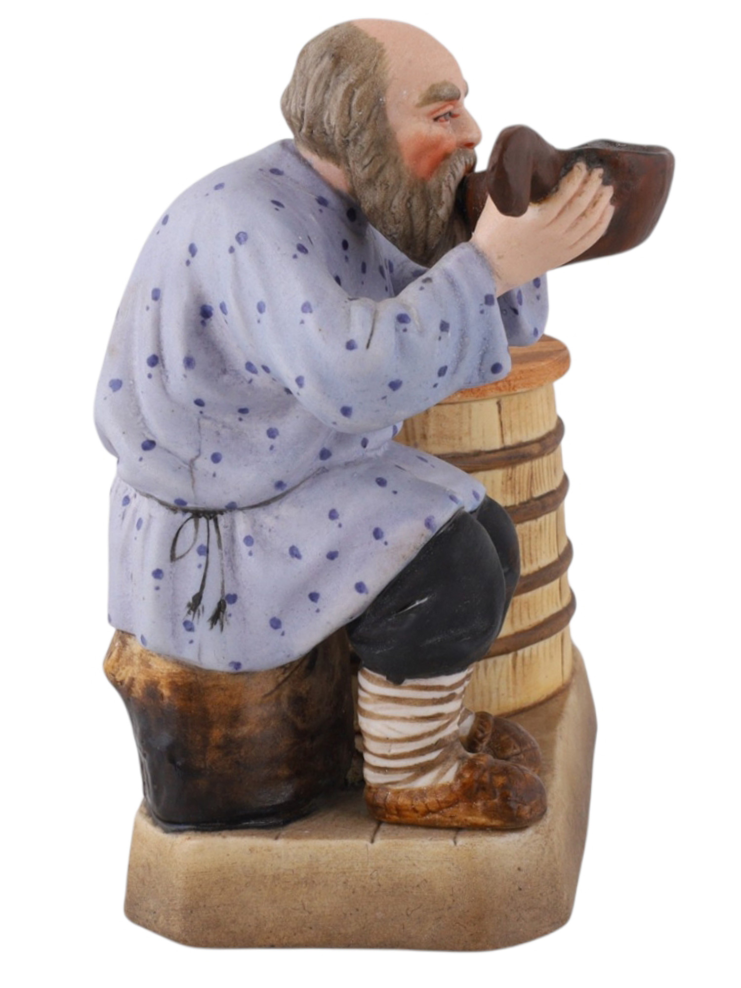 A SOVIET VERBILKI PORCELAIN FIGURAL COVERED SALT CELLAR, "THE PEASANT DRINKING FROM A KOVSH"