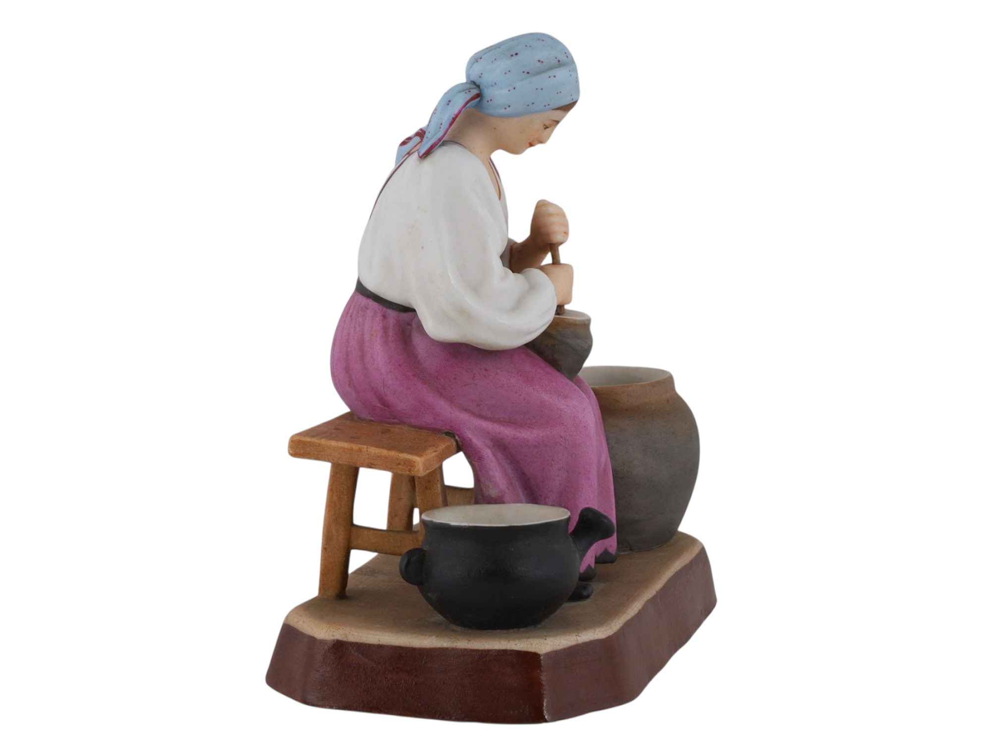 A RUSSIAN GARDNER PORCELAIN FIGURE OF A PEASANT WOMAN AT WORK, 19TH CEN.