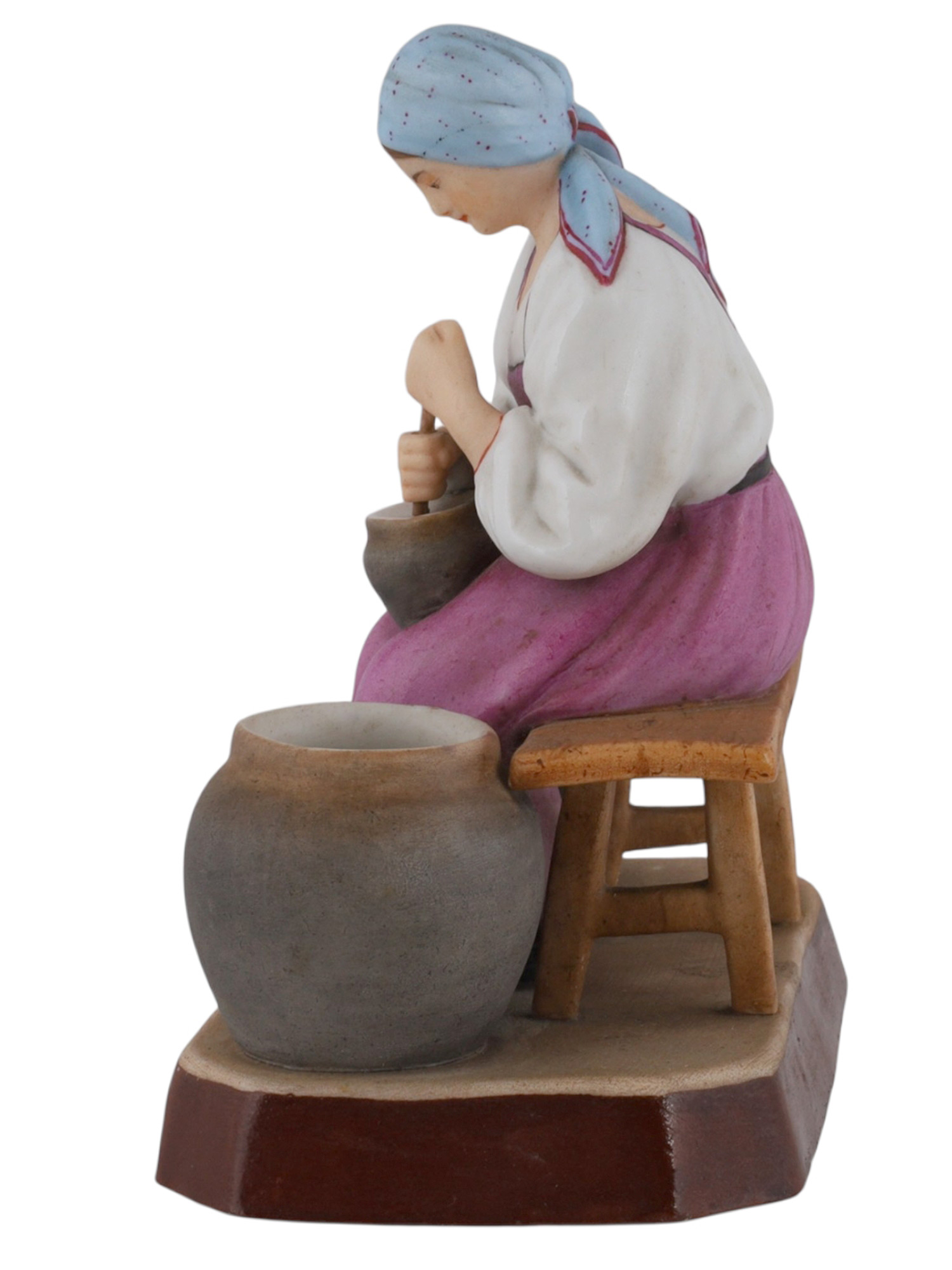 A RUSSIAN GARDNER PORCELAIN FIGURE OF A PEASANT WOMAN AT WORK, 19TH CEN.