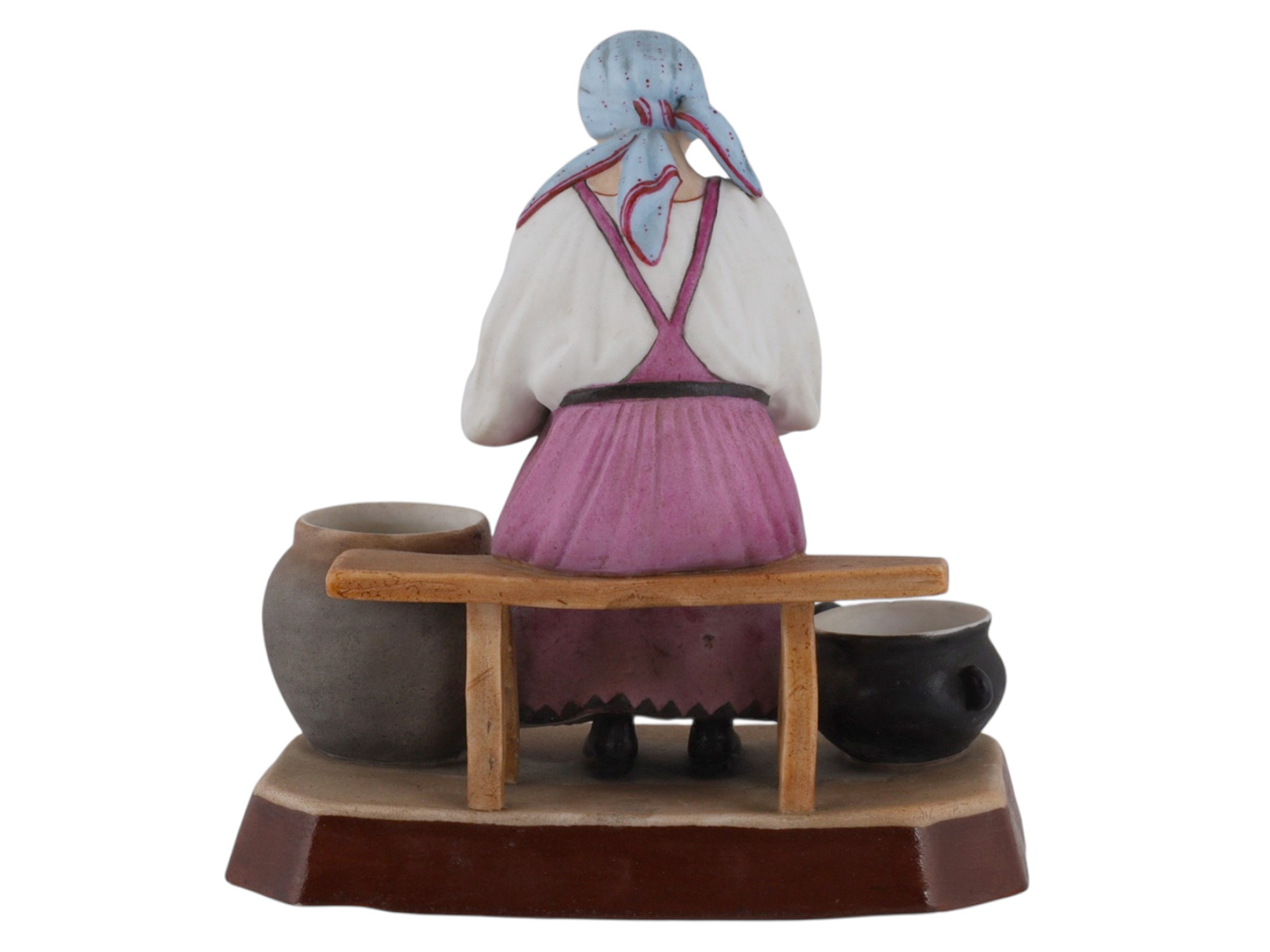 A RUSSIAN GARDNER PORCELAIN FIGURE OF A PEASANT WOMAN AT WORK, 19TH CEN.