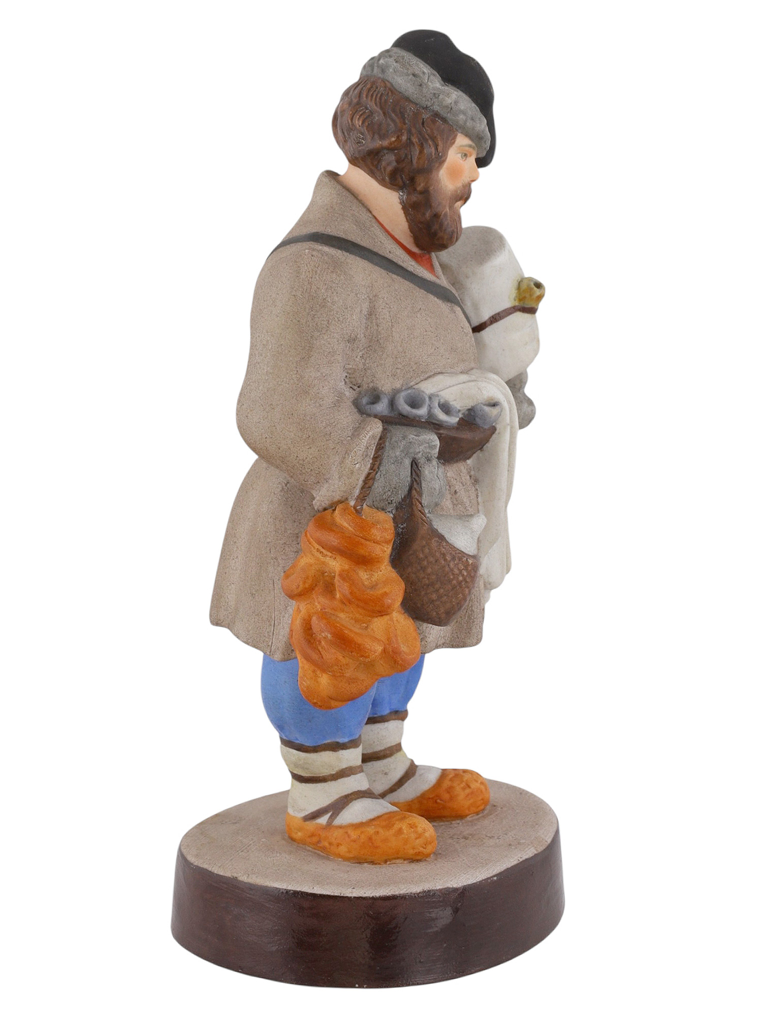 A RUSSIAN GARDENER PORCELAIN FIGURE OF A SBITENSCHIK, 19TH CENTURY