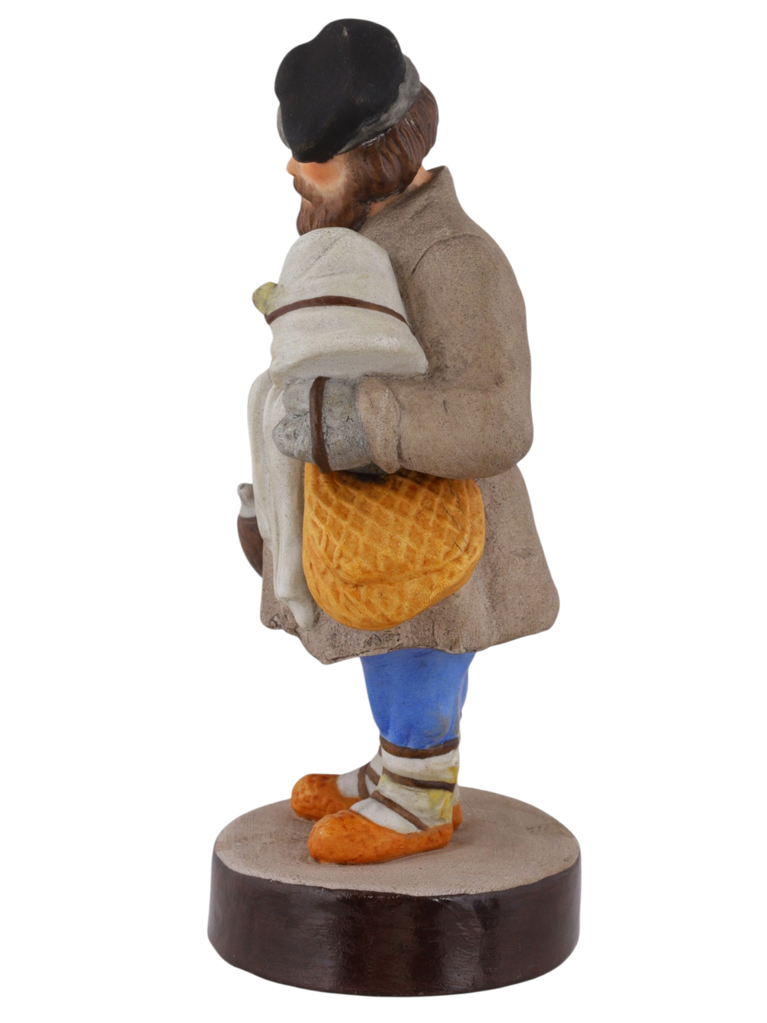 A RUSSIAN GARDENER PORCELAIN FIGURE OF A SBITENSCHIK, 19TH CENTURY