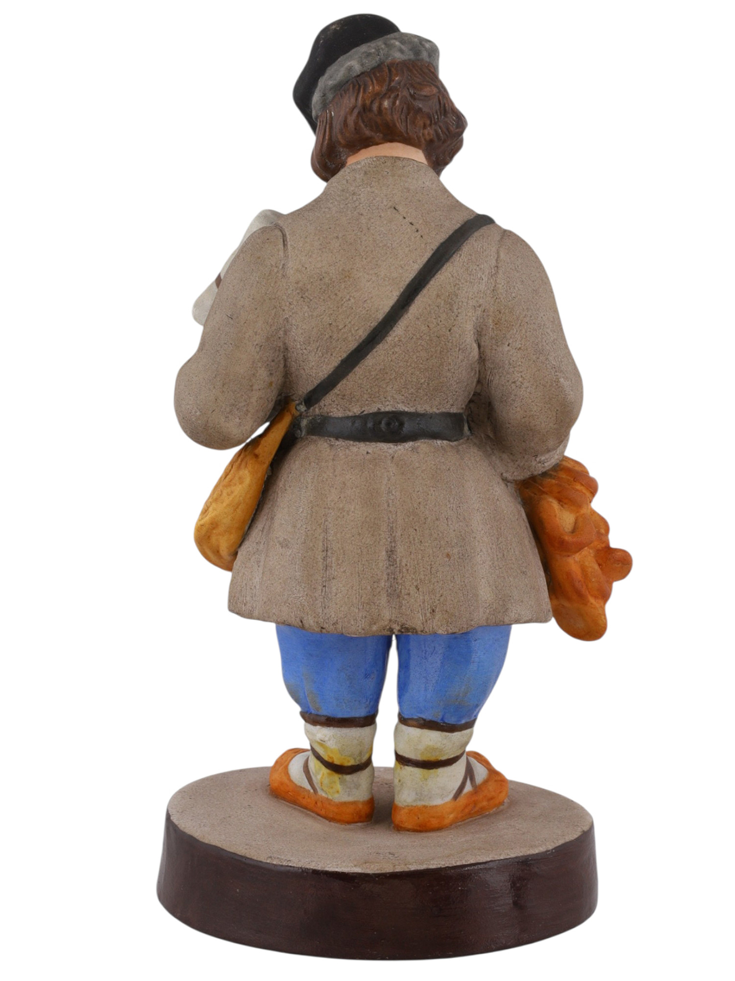 A RUSSIAN GARDENER PORCELAIN FIGURE OF A SBITENSCHIK, 19TH CENTURY